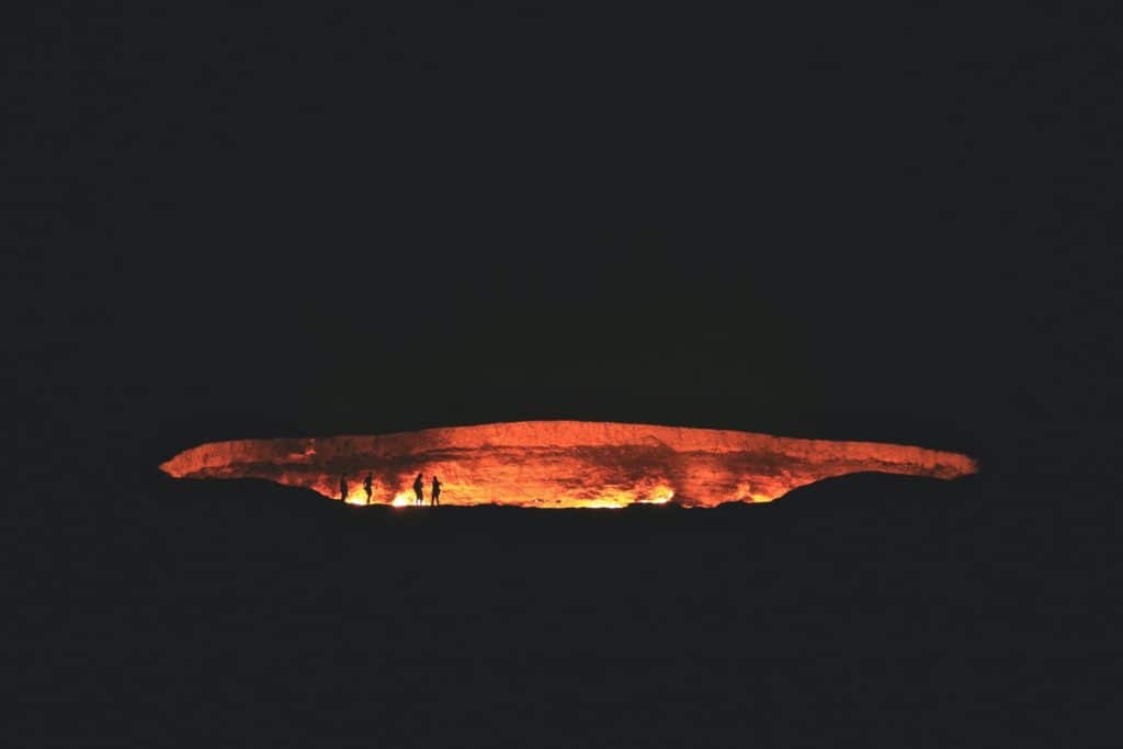 photography of people near cave at night time