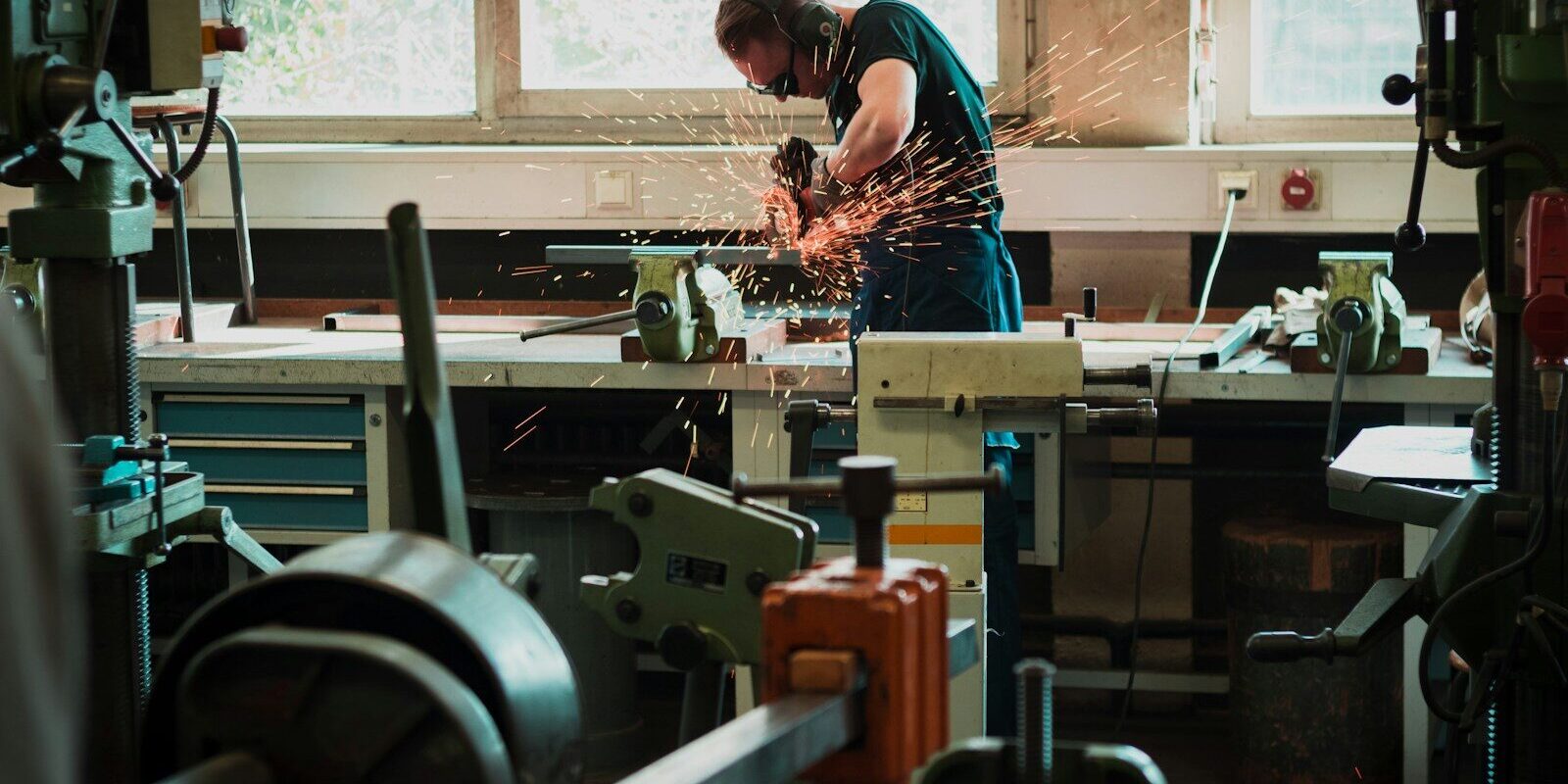 selective focus photography of man using angle grinder